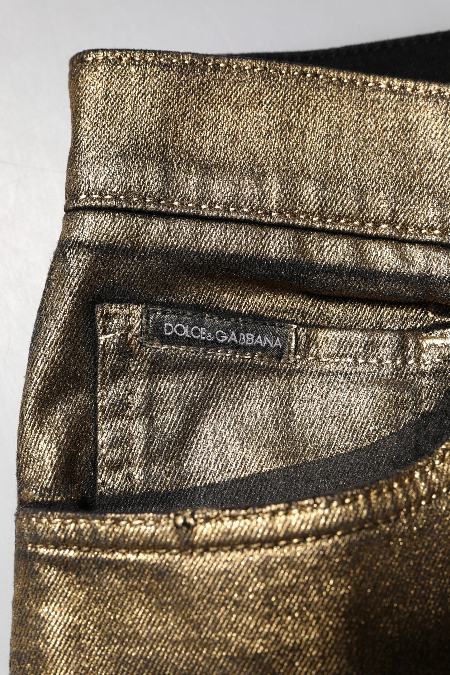 Dolce & Gabbana – Schmale Jeans aus zerfetzter Baumwolle und Stretch in Gold