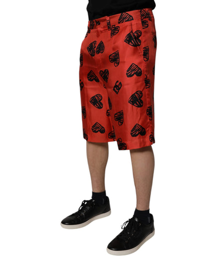 Dolce &amp; Gabbana – Orangefarbene Bermudashorts aus Seide mit Herz-Print