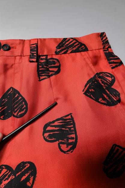 Dolce &amp; Gabbana – Orangefarbene Bermudashorts aus Seide mit Herz-Print
