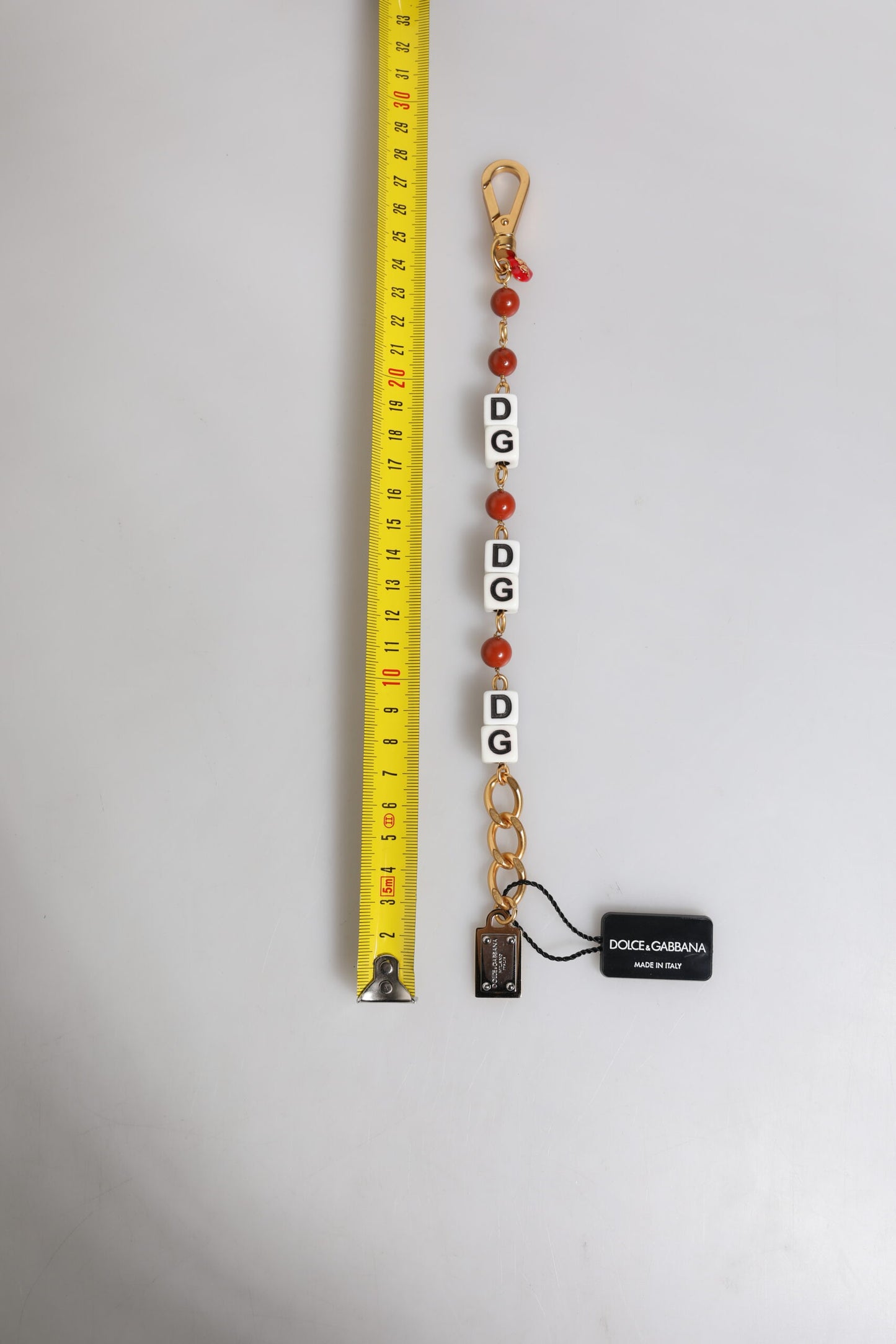 Dolce &amp; Gabbana – Mehrfarbiges, goldfarbenes Messingkettenarmband mit DG-Logo und Würfeln