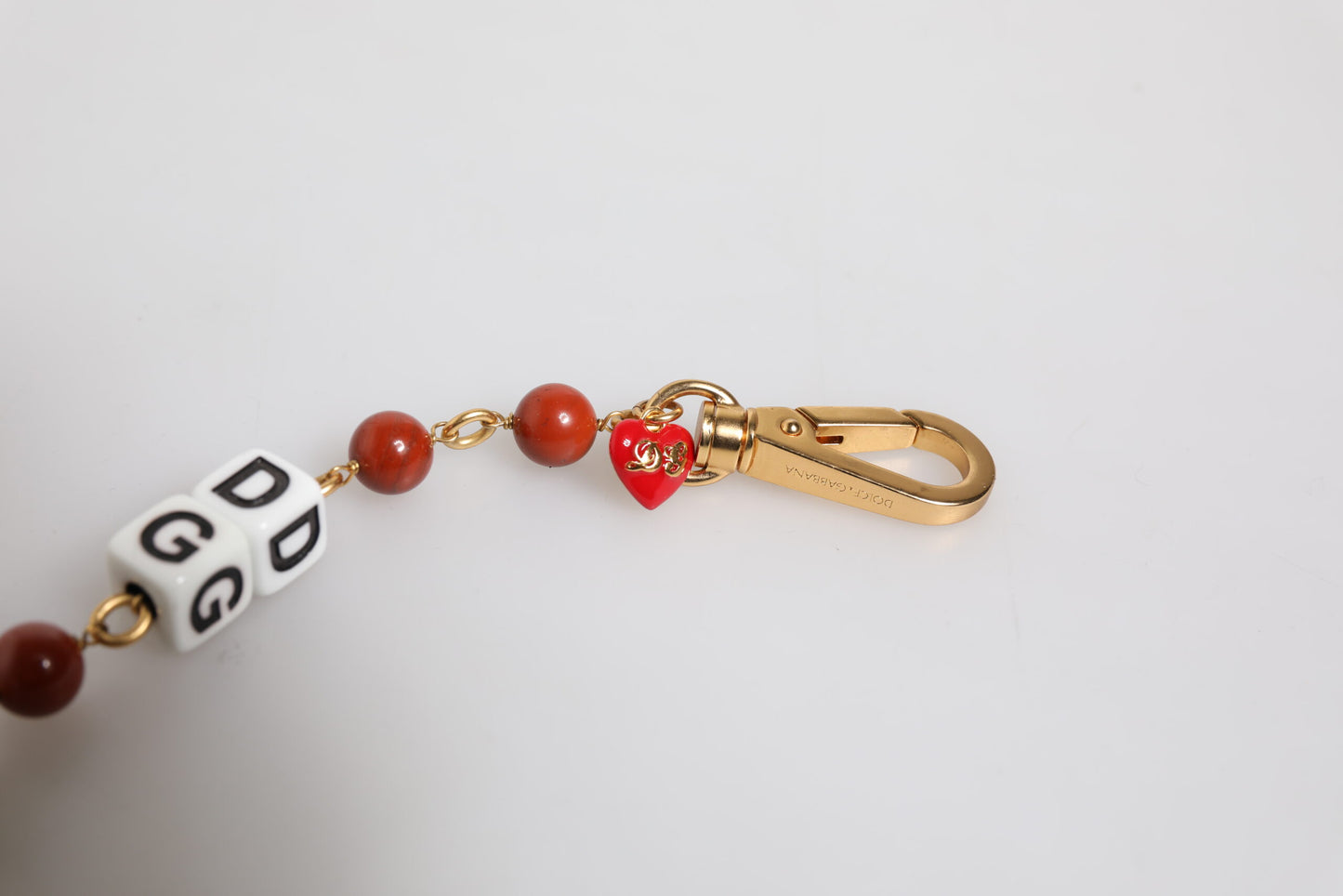 Dolce &amp; Gabbana – Mehrfarbiges, goldfarbenes Messingkettenarmband mit DG-Logo und Würfeln