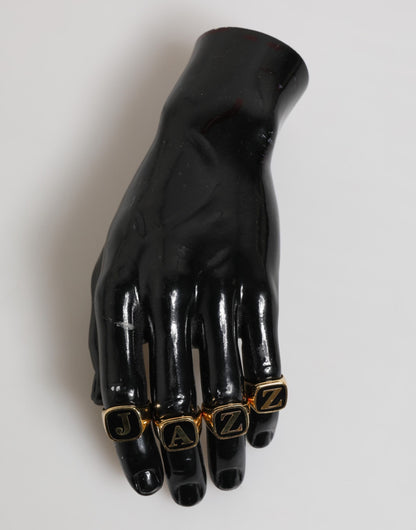Dolce &amp; Gabbana – Goldfarbenes Messing-Buchstabenset „JAZZ“, 4-teilig, verstellbarer Ring